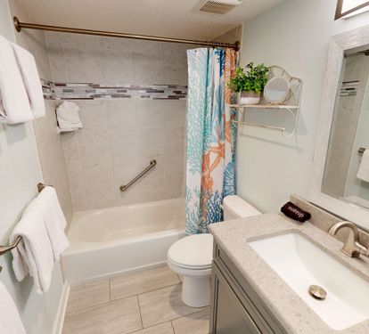 Refresh in your private bathroom with marble counters, tub-shower combo, and plush towels ready for your comfort.