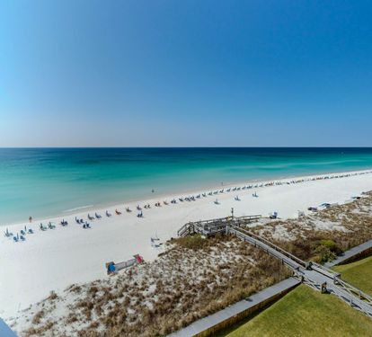 Stunning beachfront location with pristine white sand, turquoise waters, and direct beach access via wooden walkway.