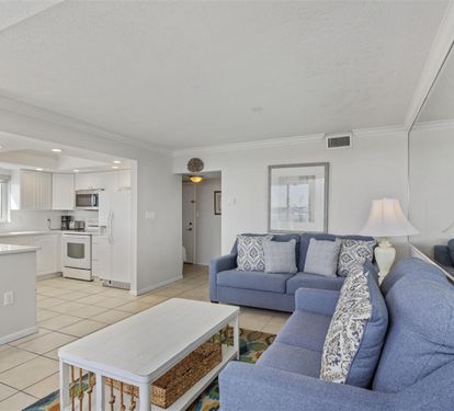 Unwind in your bright, open living space where coastal blues meet crisp whites, creating the perfect backdrop for memorable vacation moments.