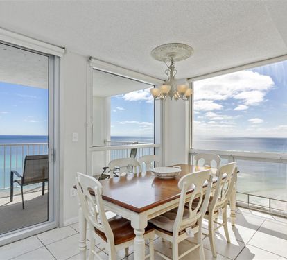 Enjoy meals with breathtaking ocean views through floor-to-ceiling windows that frame the endless blue horizon from your elegant dining space.