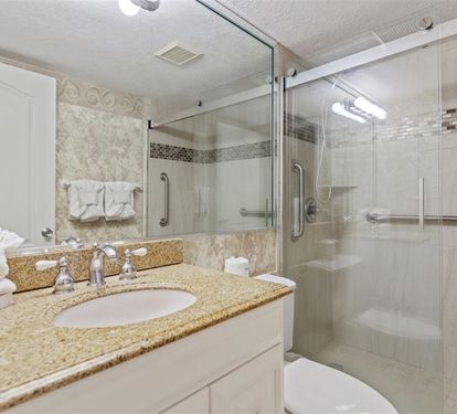 Pamper yourself in this sparkling bathroom with granite counters, glass-enclosed shower, and fresh towels awaiting your arrival.