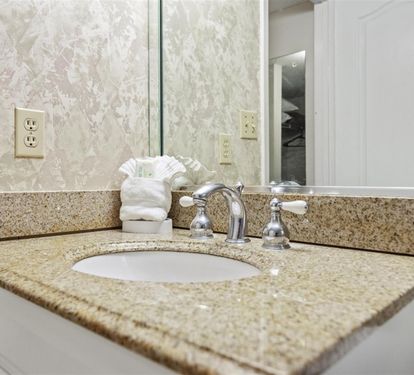 Enjoy pristine granite counters and fresh towels in your beautifully appointed bathroom, designed for comfort and convenience.
