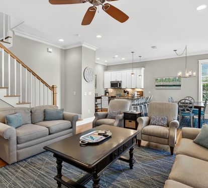 Relax in your spacious open-plan living area with comfortable seating, modern kitchen, and stylish touches that make this feel like home.