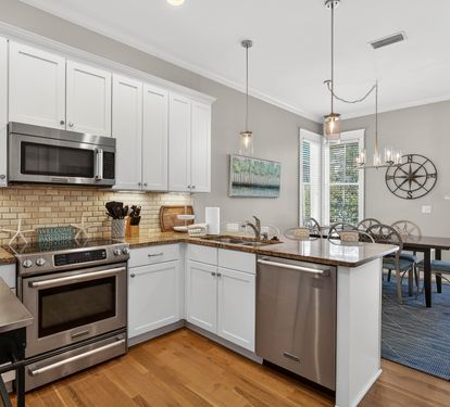 Your fully equipped kitchen flows seamlessly into the dining area, where natural light and modern fixtures create the perfect space for home-cooked meals.