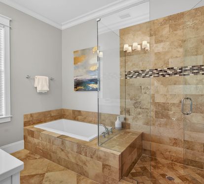 Unwind in your luxurious master bathroom featuring a spacious glass shower and elegant soaking tub, perfect for relaxing after your adventures.