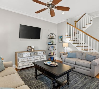 Sink into plush seating while enjoying your favorite shows on the wall-mounted TV in this inviting living space.