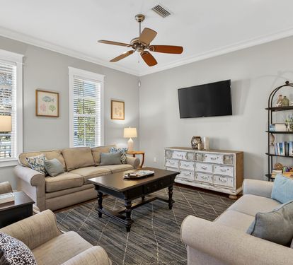 Unwind in your elegant living room featuring plush seating, warm lighting, and modern entertainment - perfect for cozy evenings after exploring.
