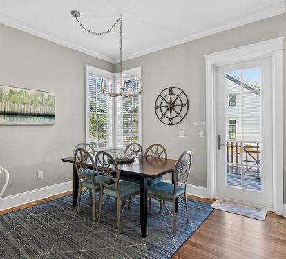 Your elegant dining room invites memorable meals with stylish coastal decor and French doors opening to your private balcony.