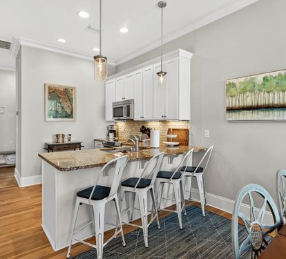 You'll love cooking in this bright, fully-equipped kitchen with granite countertops, modern appliances, and stylish breakfast bar seating.