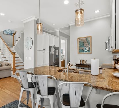 Gather around this stunning granite island where memories are made over morning coffee and evening conversations in your open-concept haven.