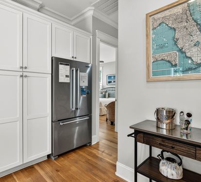 Your kitchen features sleek stainless steel appliances and ample white cabinetry, perfect for preparing memorable meals during your stay.