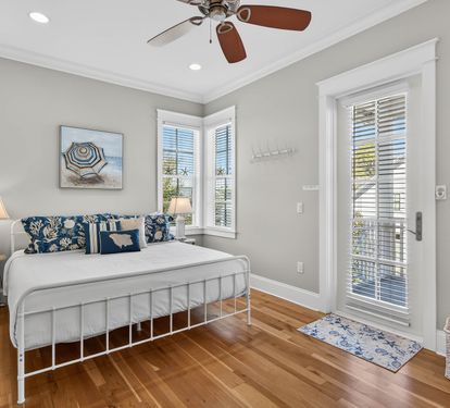 Drift off to peaceful sleep in this serene bedroom with coastal charm and natural light streaming through.