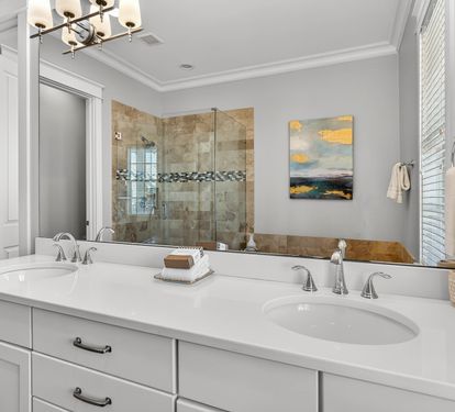 Unwind in your elegant spa-like bathroom with marble countertops, dual vanities, and a luxurious walk-in shower.