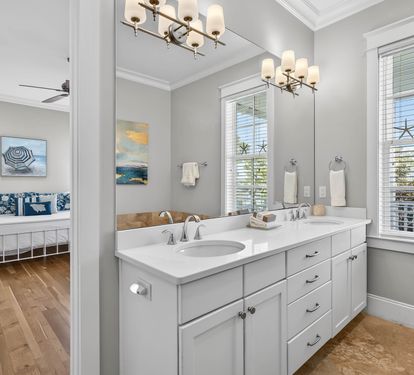 Pamper yourself in this elegant bathroom with dual vanities, perfect for getting ready together on your beach getaway.