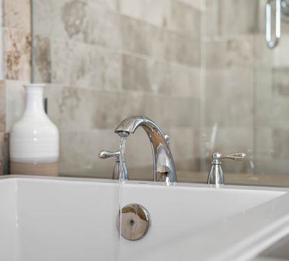 Slip into your elegant marble-tiled bathroom and unwind in the deep soaking tub with polished chrome fixtures.