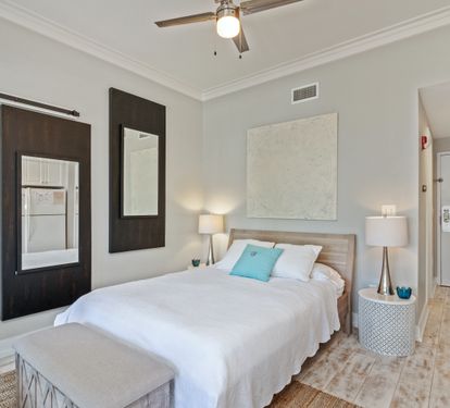 Serene sleeping space with a cozy queen bed, modern coastal accents, and calming neutral tones—perfect for unwinding after a day on 30A.