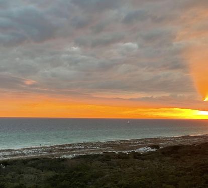 The sun is setting over the Gulf of Mexico.