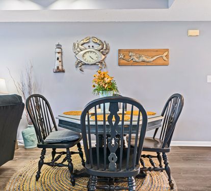 You'll love gathering around this charming coastal dining table, where nautical décor and warm touches create the perfect spot for memorable meals together.