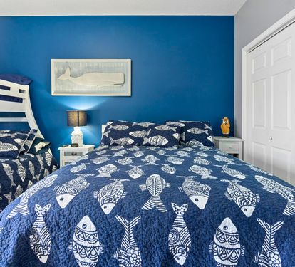 Dive into coastal dreams in your charming blue bedroom, where nautical fish patterns and ocean-inspired decor create the perfect seaside retreat.