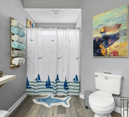 Freshen up in your coastal-themed bathroom, complete with nautical artwork and soft towels ready for your comfort.