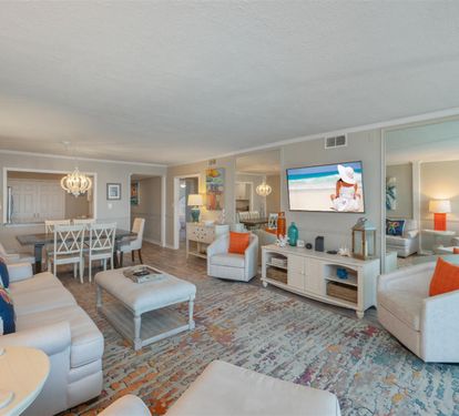 Relax in your elegantly appointed living space featuring plush seating, coastal decor, and modern entertainment.