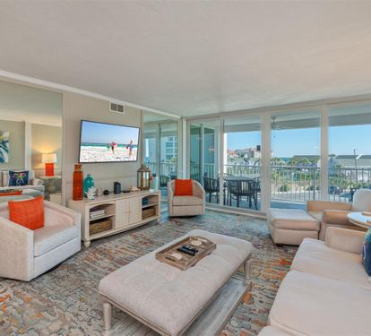 Relax in your bright living room with panoramic views, comfortable seating, and vibrant coastal touches that make you feel right at home.