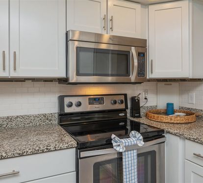 Your modern kitchen features stainless steel appliances and granite countertops, creating the perfect space for preparing delicious meals.