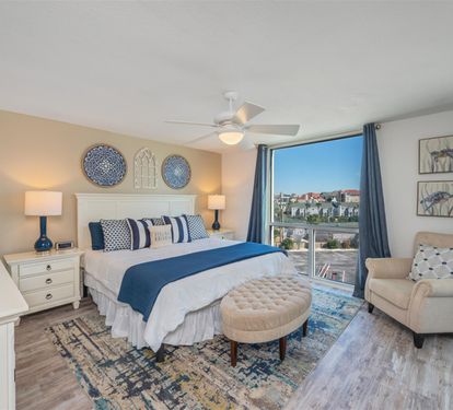 Wake to stunning city views in your serene bedroom sanctuary with coastal-inspired blues and nautical touches creating perfect relaxation.