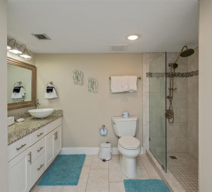 Refresh in your spacious private bathroom with granite vanity, walk-in shower, and soft turquoise accents that add coastal charm.
