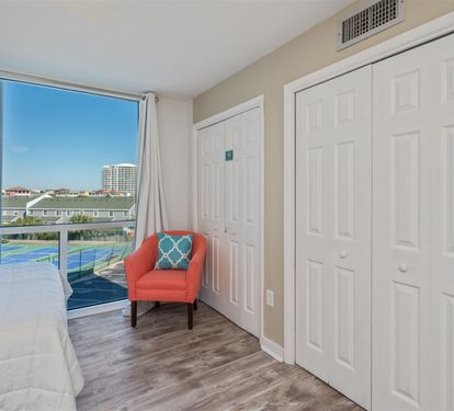 Relax in your cozy reading chair while enjoying stunning city views through the large window. Ample closet storage keeps your belongings organized.
