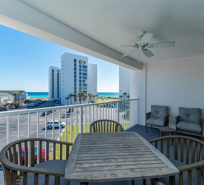 Enjoy your morning coffee at this oceanview dining table, with comfortable seating and glimpses of turquoise waters beyond the balcony.