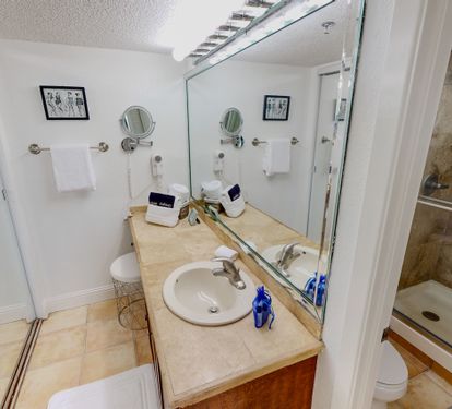 Refresh in your private bathroom with marble counters, walk-in shower, and thoughtful amenities ready for your comfort.