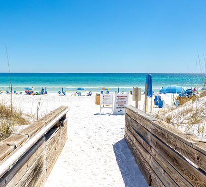 A direct beach access path from the property leads to pristine white sands and sparkling turquoise waters, perfect for your sunny beach days.