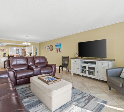 Sink into rich leather seating while you watch your favorite shows on the large flat-screen TV in this spacious, sunlit living area.