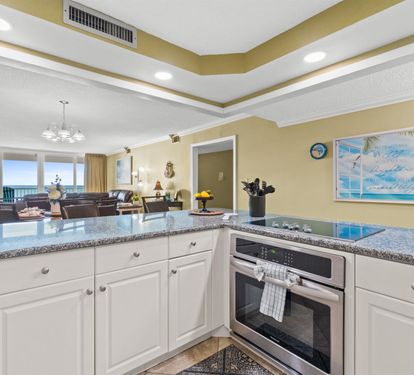 Your spacious kitchen features granite countertops and ocean views, perfect for preparing meals while soaking in coastal beauty.