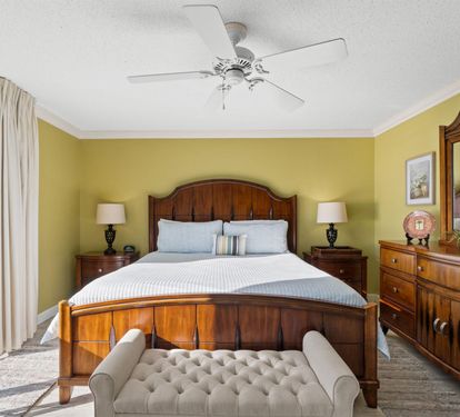 Sink into your elegant bed surrounded by warm wood furnishings and cheerful yellow walls, with city views from your window.