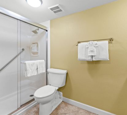 Your private bathroom features a spacious walk-in shower, fresh towels, and thoughtful accessibility features for your comfort.