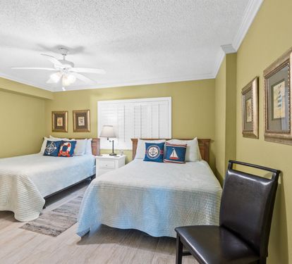 Unwind in this charming twin bedroom with coastal touches and comfortable seating for your seaside getaway.