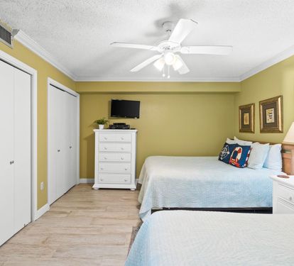 Relax in your bright, cheerful bedroom with two comfortable beds, ceiling fan, and all the storage you need for a perfect getaway.
