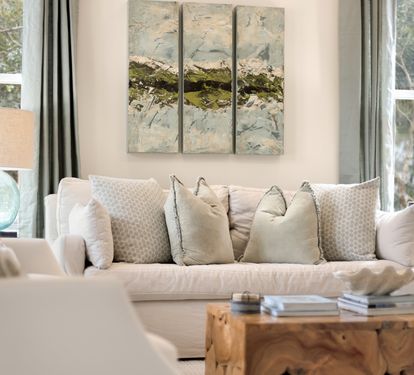 Sink into plush cushions in your serene living space, where soft blues and natural light create the perfect retreat for relaxation.