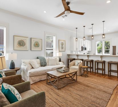 Relax in your spacious open-concept living space with coastal decor, comfortable seating, and a chef's kitchen perfect for vacation meals.