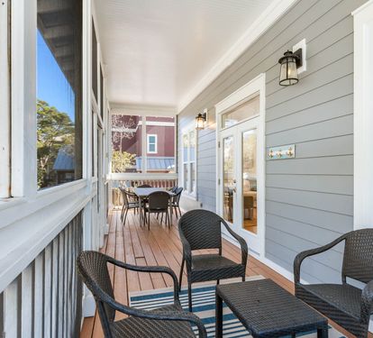 Your private porch offers cozy seating where you can sip morning coffee while watching the neighborhood come alive.