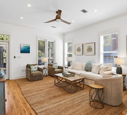 Sink into plush seating in this bright living space where coastal artwork and natural textures create your perfect retreat.