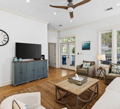 Relax in your bright living room with comfortable seating, large flat-screen TV, and doors opening to your private outdoor space.