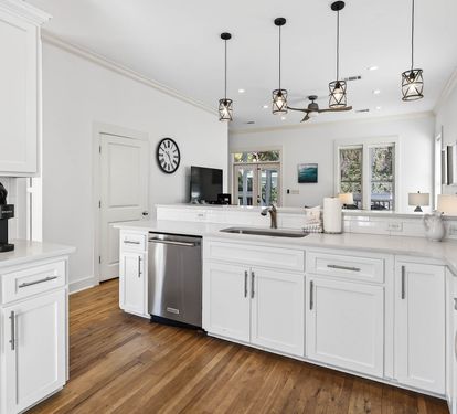 Your dream kitchen awaits with crisp white cabinetry, quartz countertops, and modern pendant lighting creating the perfect space for memorable meals.