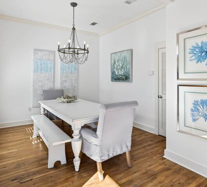 Your elegant dining space features coastal artwork and natural light, perfect for memorable meals with loved ones.