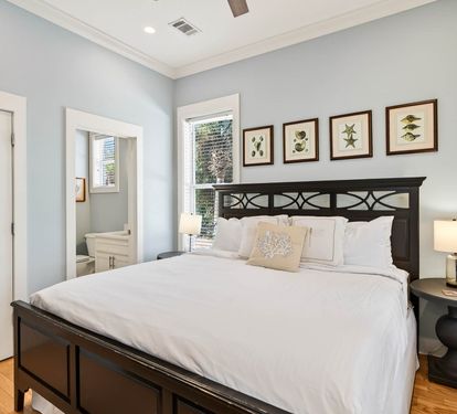 Drift into peaceful sleep in your serene coastal bedroom with crisp white linens and botanical artwork creating a tranquil sanctuary.