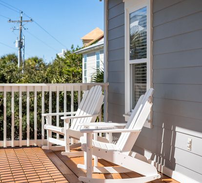 Soak up the sunshine on your private balcony with classic Adirondack chairs—perfect for morning coffee or sunset relaxation.