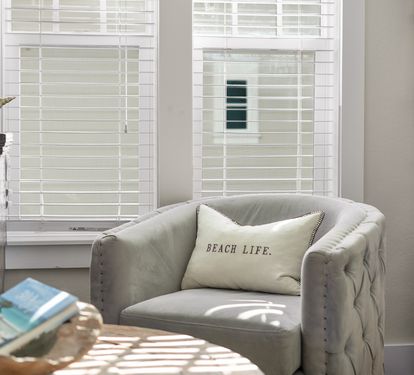 Sink into this plush armchair with your morning coffee as gentle sunlight filters through plantation shutters, creating the perfect reading nook.