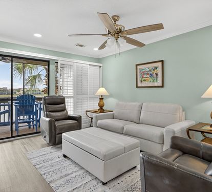 Unwind in your spacious living area with comfortable leather seating, tropical breezes from your private balcony, and soothing coastal views to enhance your relaxation.